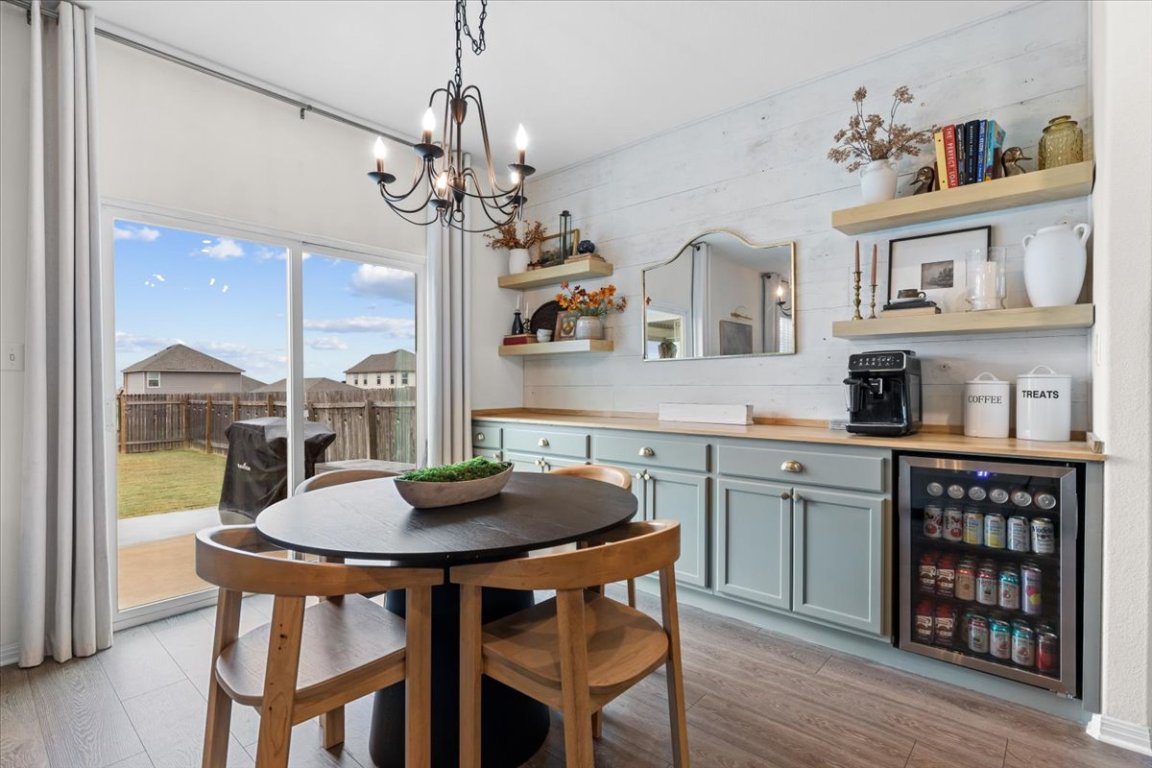 19305 Nathan Scott Way Manor, TX 78653 - Photo 6 of 18 a view of a dining room with furniture window and wooden floor