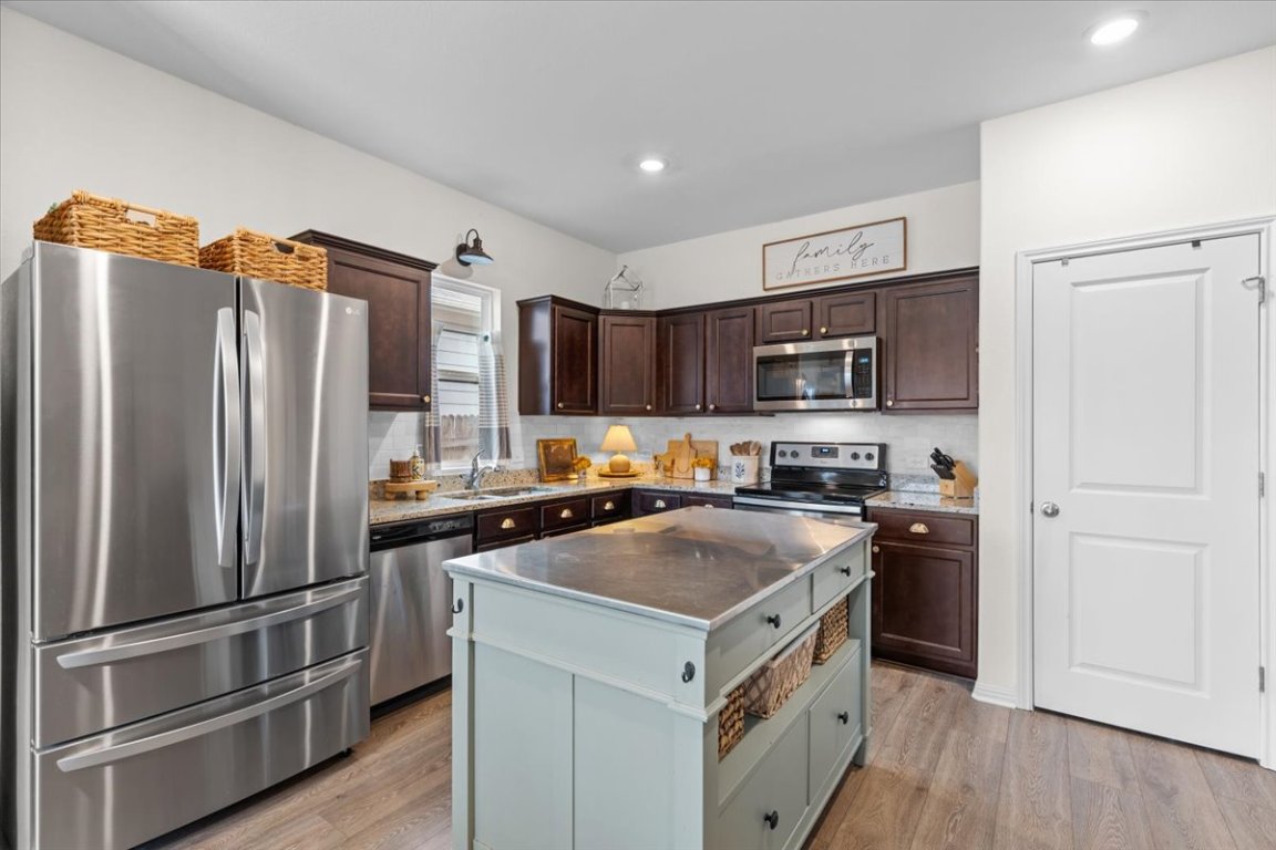19305 Nathan Scott Way Manor, TX 78653 - Photo 7 of 18 a kitchen with a refrigerator stove and microwave