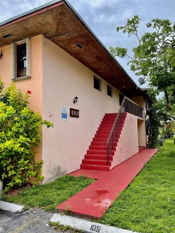 a backyard of a house with wooden floor and outdoor space