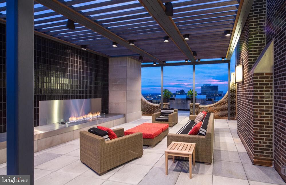 a outdoor living space with patio furniture and a grill