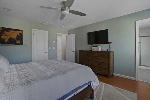 a bedroom with a bed and a flat screen tv