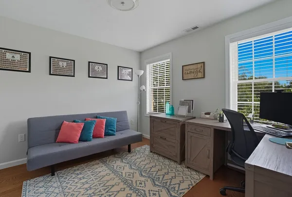 a living room with furniture rug and window