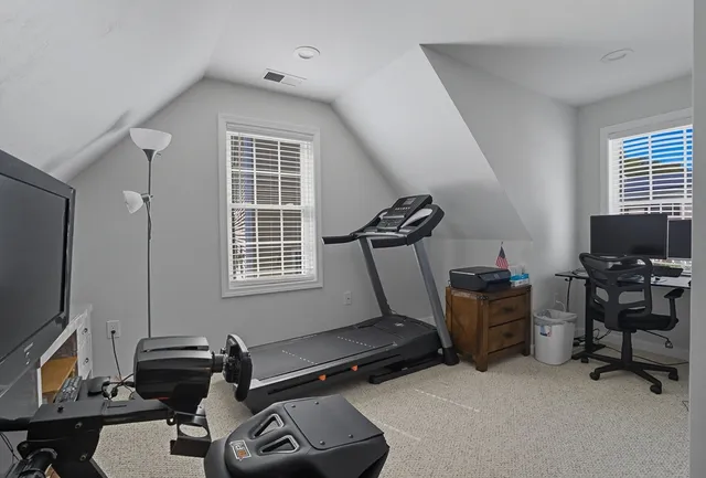a room with gym equipment and a flat screen tv