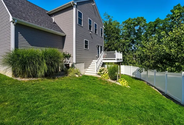 a view of a house with a yard and sitting area