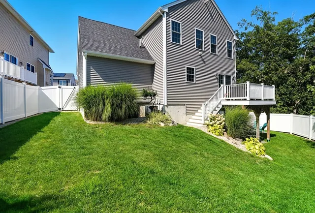 a view of a house with a yard and sitting area