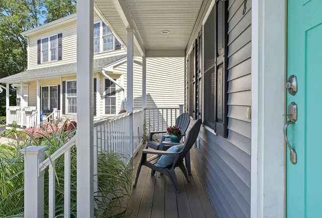 a view of balcony with wooden floor and outdoor seating