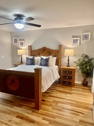 a bedroom with a bed and a potted plant