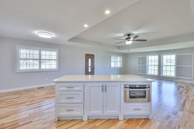 a kitchen with a stove cabinets and wooden floor