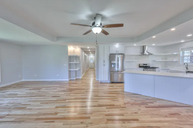 a view of kitchen with granite countertop cabinets and refrigerator