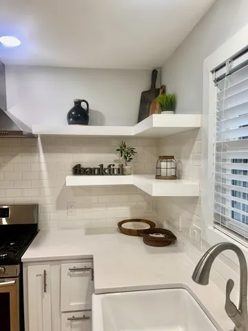 a kitchen with a sink a stove and cabinets