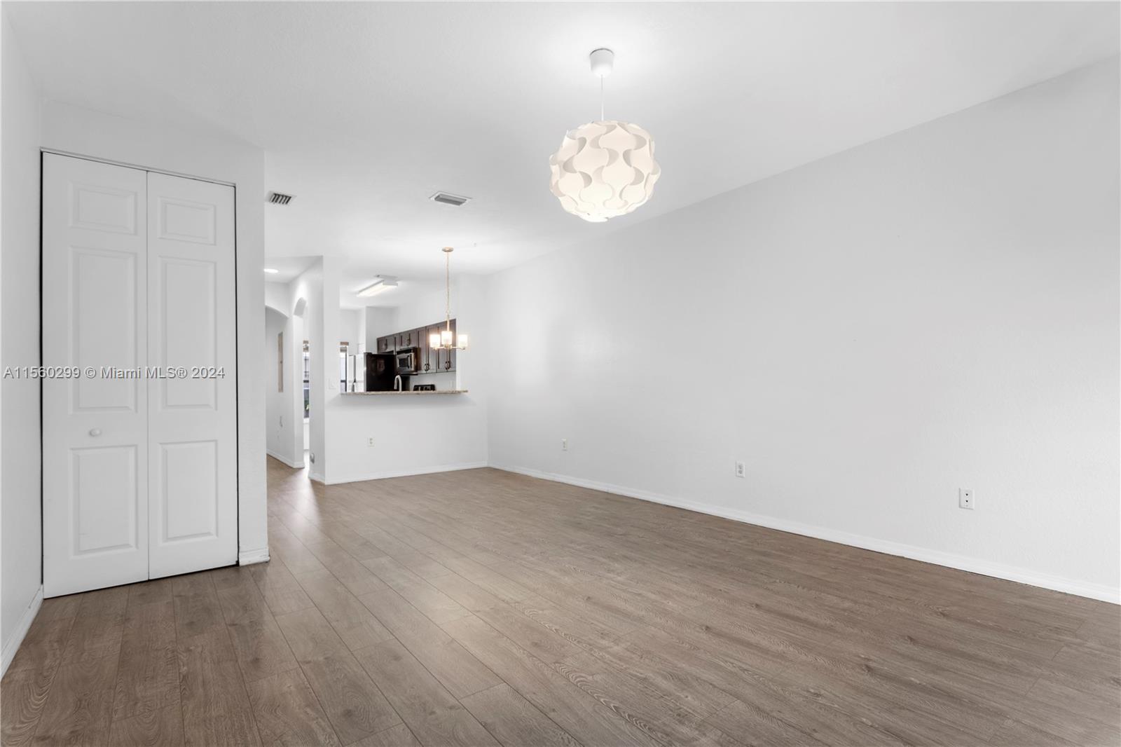 14033 Southwest 49th Street, Unit 6 Miramar, FL 33027 - Photo 11 of 25 an empty room with wooden floor and windows