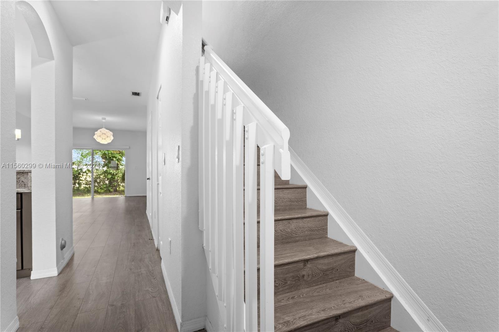 14033 Southwest 49th Street, Unit 6 Miramar, FL 33027 - Photo 15 of 25 a view of a hallway with wooden floor and staircase