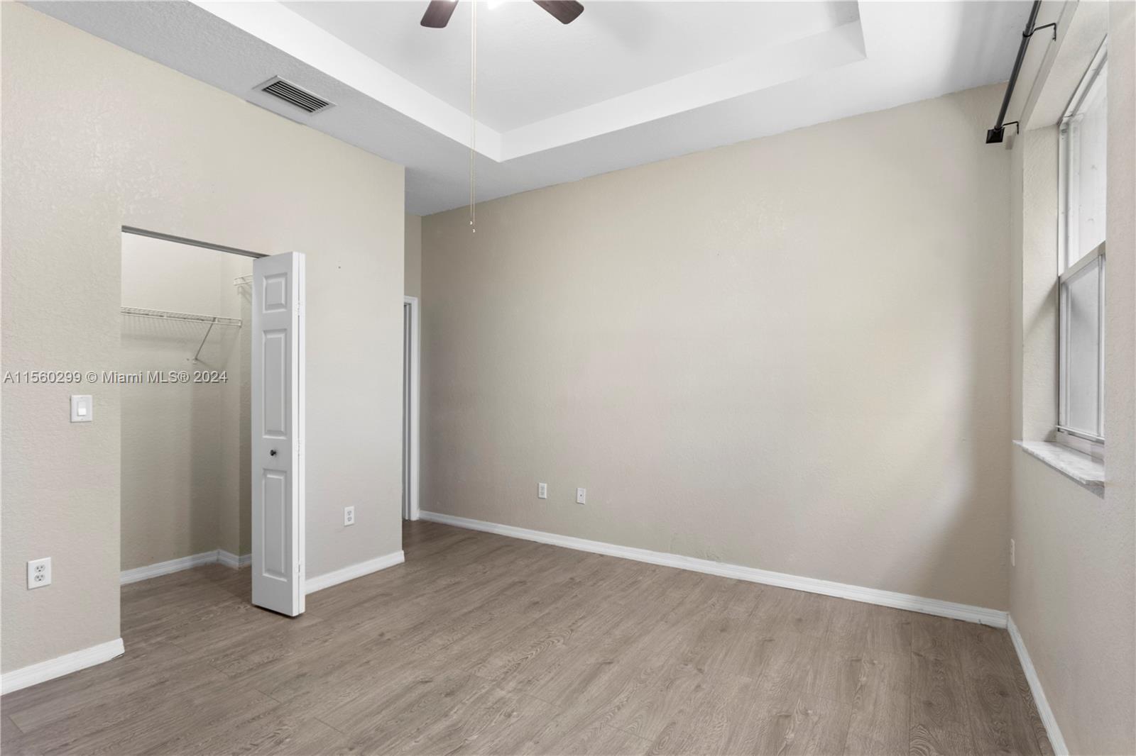 14033 Southwest 49th Street, Unit 6 Miramar, FL 33027 - Photo 17 of 25 an empty room with wooden floor and entrance