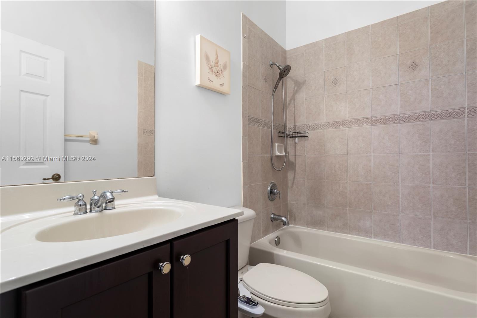 14033 Southwest 49th Street, Unit 6 Miramar, FL 33027 - Photo 19 of 25 a bathroom with a sink vanity toilet and shower