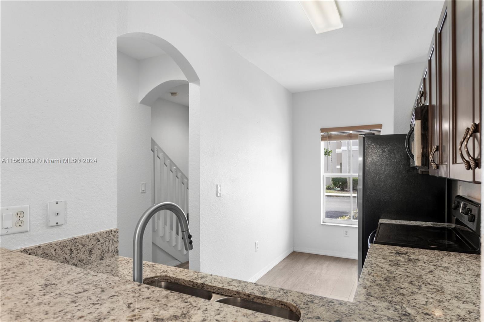 14033 Southwest 49th Street, Unit 6 Miramar, FL 33027 - Photo 7 of 25 a view of a livingroom with wooden floor and a sink