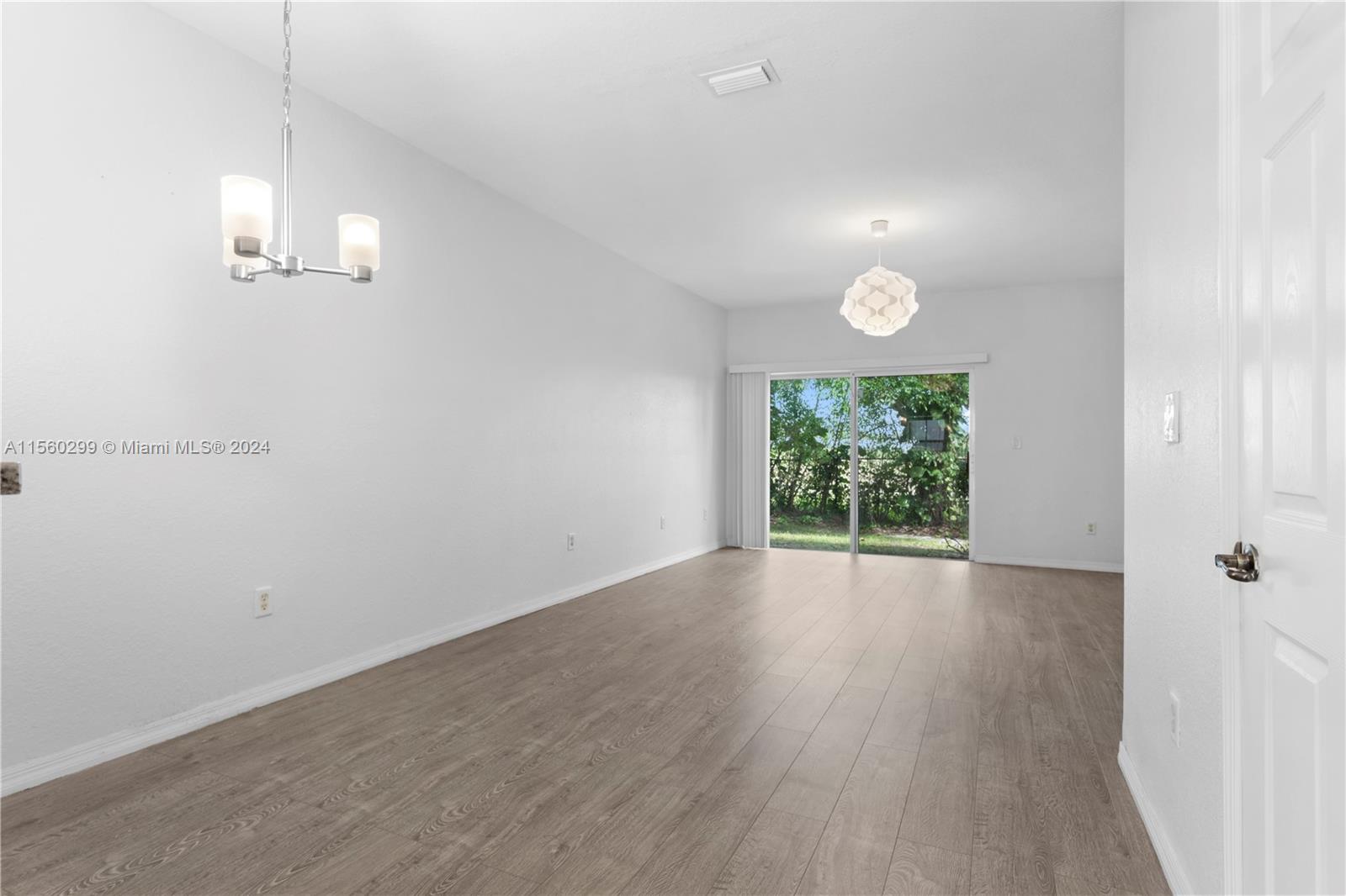 14033 Southwest 49th Street, Unit 6 Miramar, FL 33027 - Photo 8 of 25 an empty room with wooden floor and windows