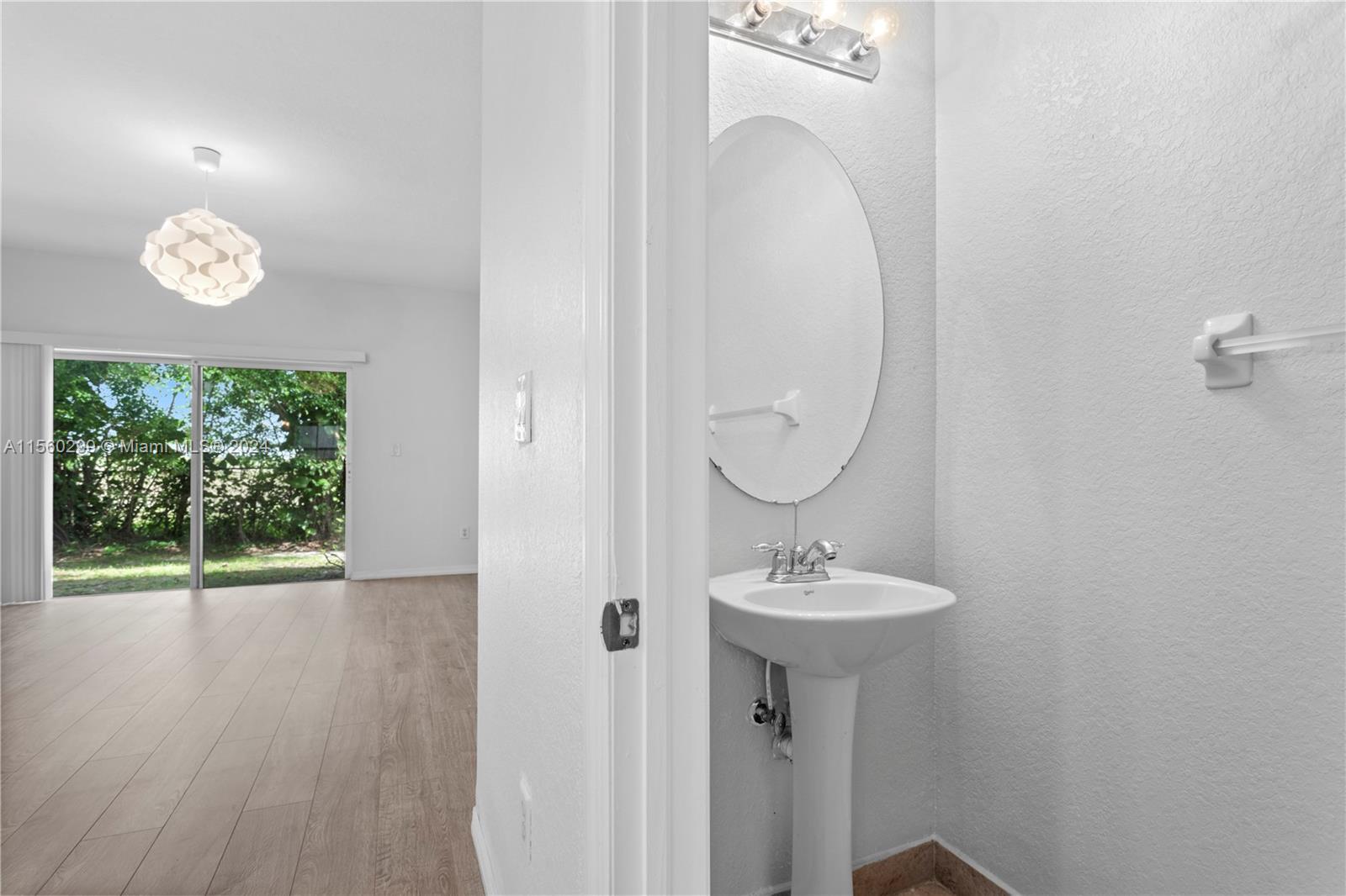 14033 Southwest 49th Street, Unit 6 Miramar, FL 33027 - Photo 10 of 25 a bathroom with a sink and a mirror