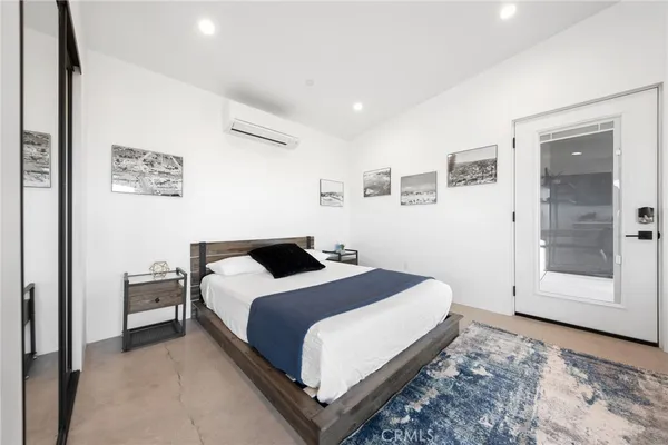 a bedroom with a bed and window