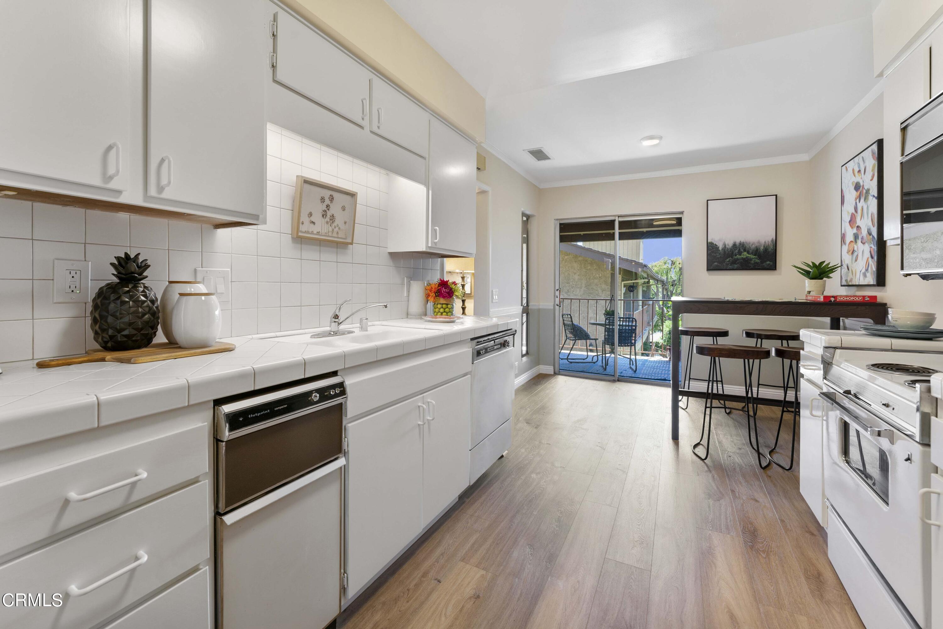 1161 West Duarte Road, Unit 20 Arcadia, CA 91007 - Photo 4 of 6 a kitchen with stainless steel appliances granite countertop a lot of counter space and wooden floors