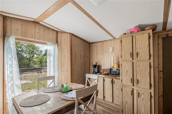 a kitchen with a table and chairs
