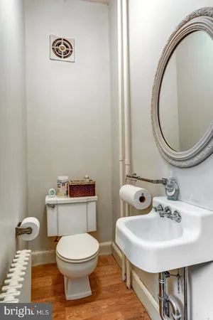a bathroom with a toilet a sink and a mirror