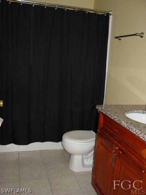 9099 Bryant Road Fort Myers, FL 33967 - Photo 5 of 8 a bathroom with a granite countertop toilet and a sink