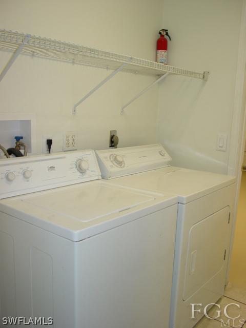 9099 Bryant Road Fort Myers, FL 33967 - Photo 7 of 8 a utility room with dryer and washer