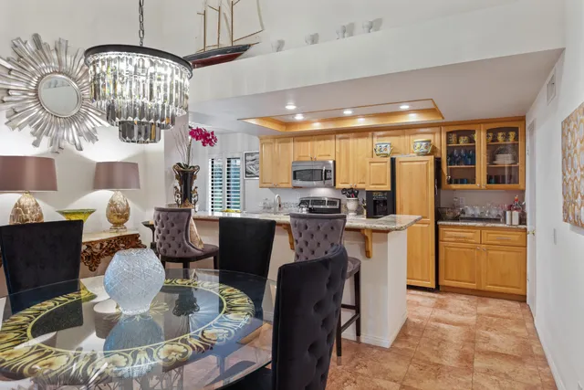 a kitchen with stainless steel appliances granite countertop a refrigerator stove and microwave