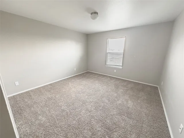 a view of an empty room and a window