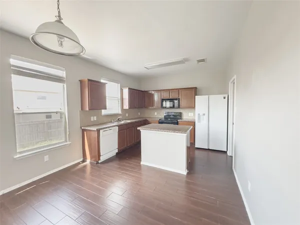 a kitchen with granite countertop wooden cabinets and a stainless steel appliances