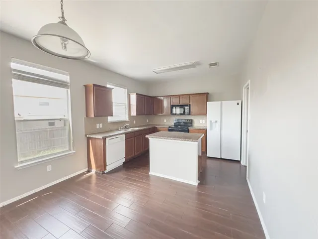 a kitchen with granite countertop wooden cabinets and a stainless steel appliances