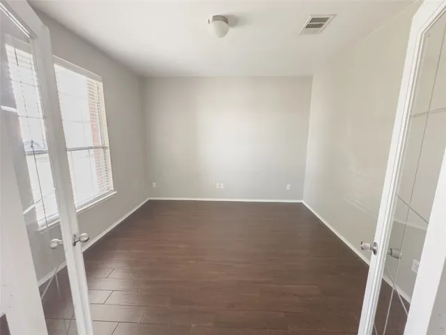 a view of a room with wooden floor