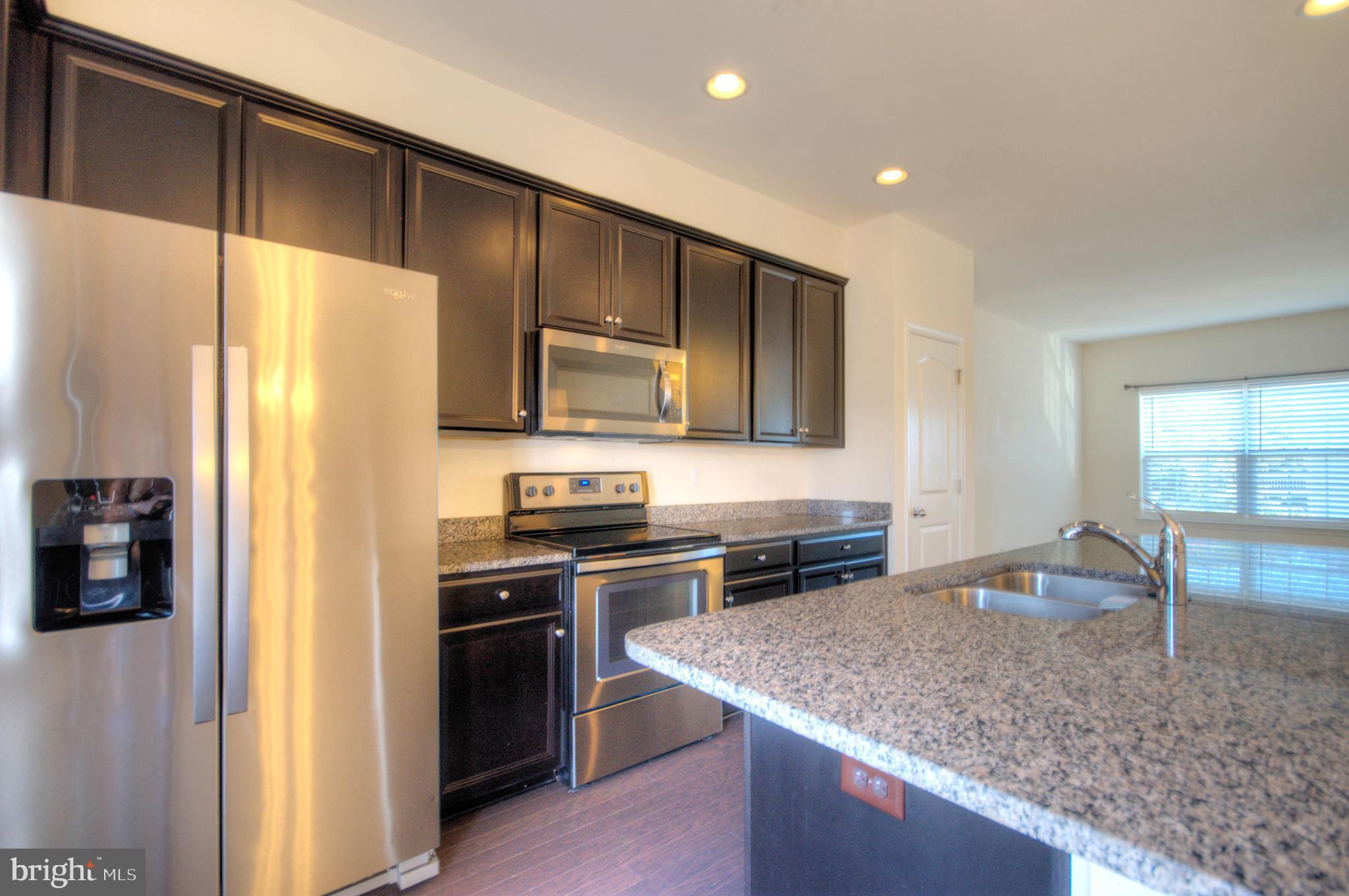 58 Iron Gate Road Marlton, NJ 08053 - Photo 17 of 47 a kitchen with stainless steel appliances granite countertop wooden cabinets a sink and a refrigerator