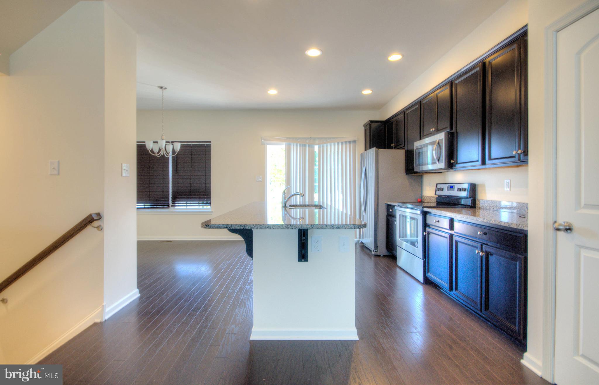 58 Iron Gate Road Marlton, NJ 08053 - Photo 23 of 47 a kitchen with stainless steel appliances kitchen island granite countertop a stove a sink and a refrigerator