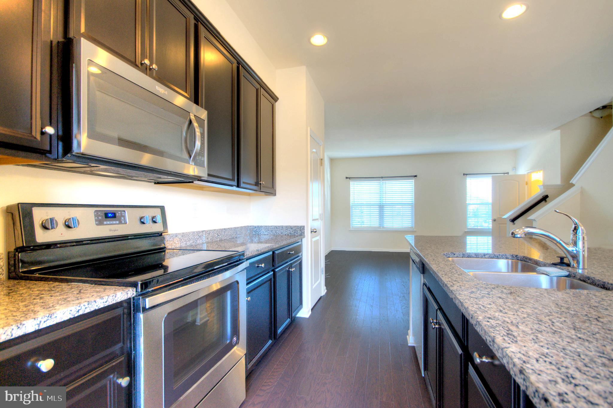 58 Iron Gate Road Marlton, NJ 08053 - Photo 29 of 47 a kitchen with stainless steel appliances granite countertop a stove a sink and a microwave
