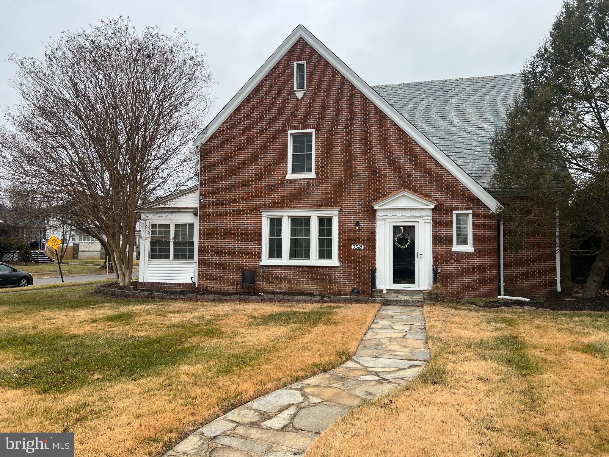 3318 Dorchester Road Baltimore, MD 21215 - Photo 2 of 5 a front view of house with yard and trees around