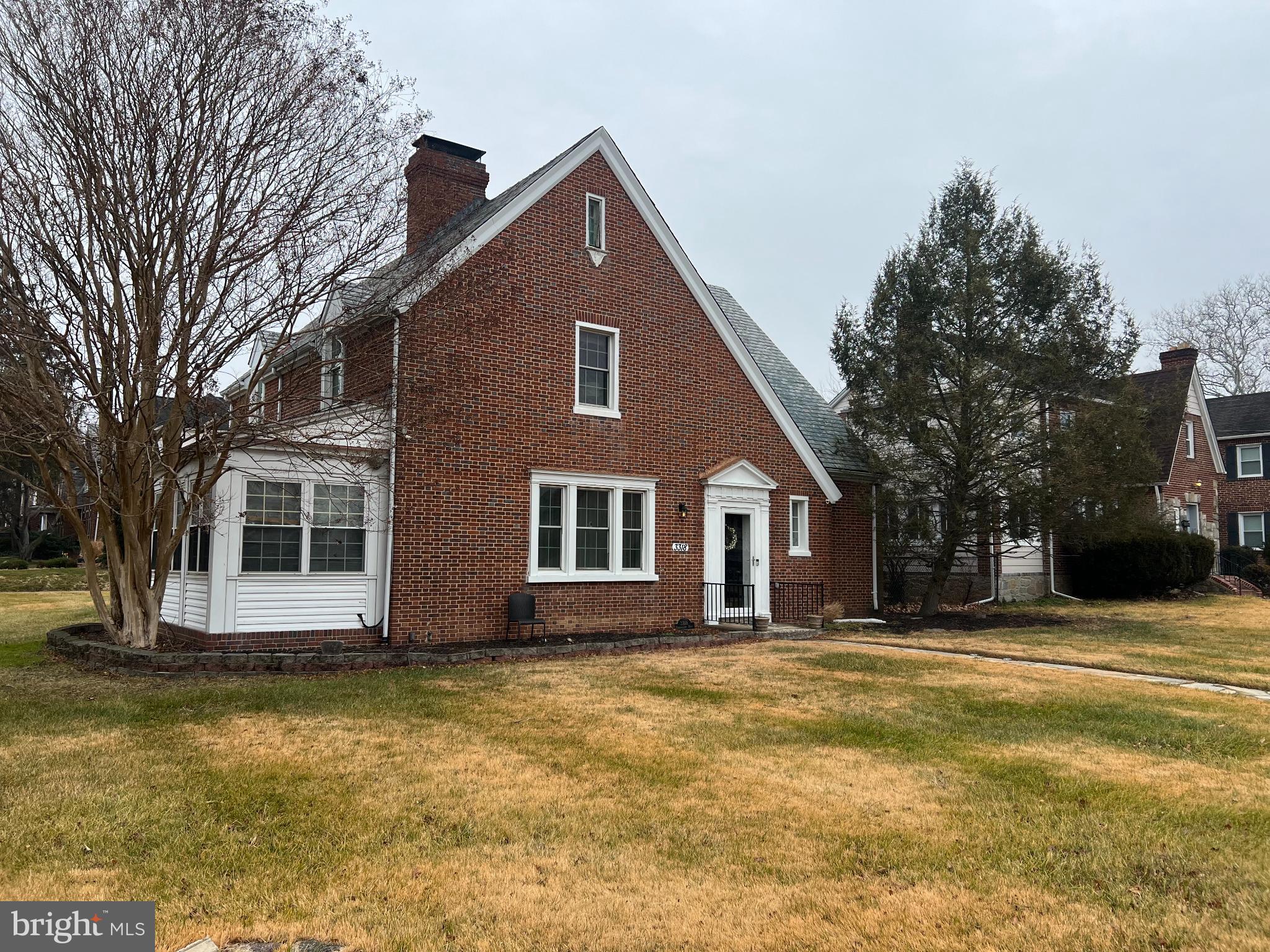 3318 Dorchester Road Baltimore, MD 21215 - Photo 4 of 5 a front view of a house with a yard