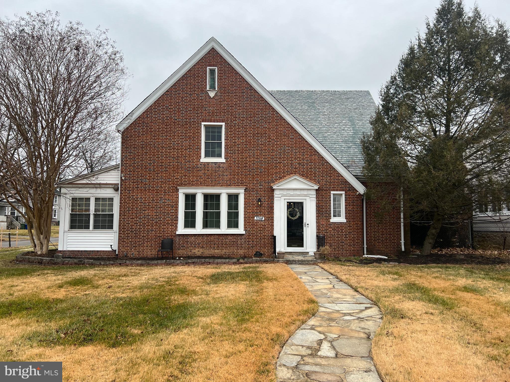 3318 Dorchester Road Baltimore, MD 21215 - Photo 5 of 5 a front view of a house with a yard