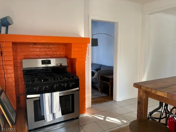 a kitchen with stainless steel appliances granite countertop a stove and a refrigerator