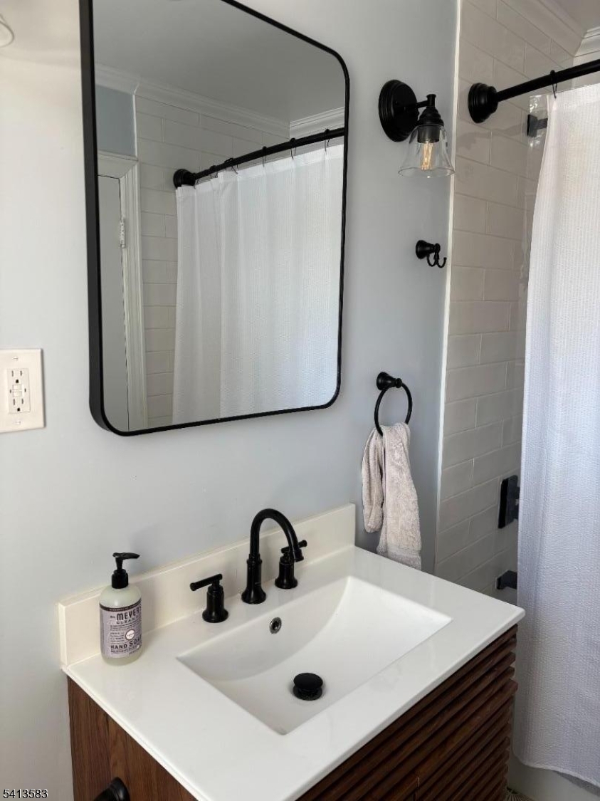 32 Pitt Street Bloomfield, NJ 07003 - Photo 6 of 10 a bathroom with a sink and a mirror