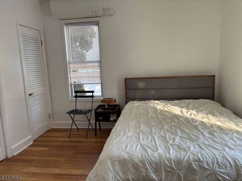 32 Pitt Street Bloomfield, NJ 07003 - Photo 8 of 10 a bedroom with a bed and a table