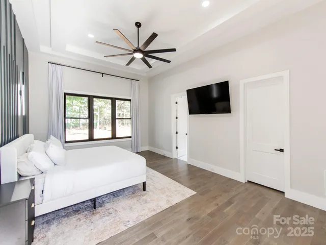 a bedroom with a large bed and a flat screen tv