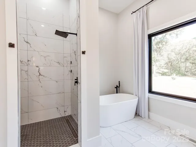 a bathroom with a bathtub and shower