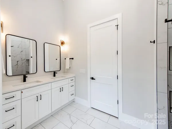 a spacious bathroom with a double vanity sink and a mirror