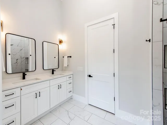 a spacious bathroom with a double vanity sink and a mirror