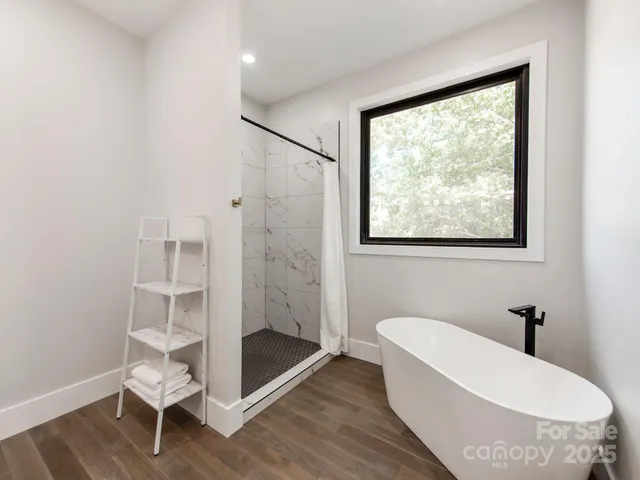 a bathroom with a tub toilet and a shower