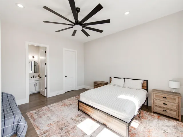 a bedroom with a bed and a chandelier