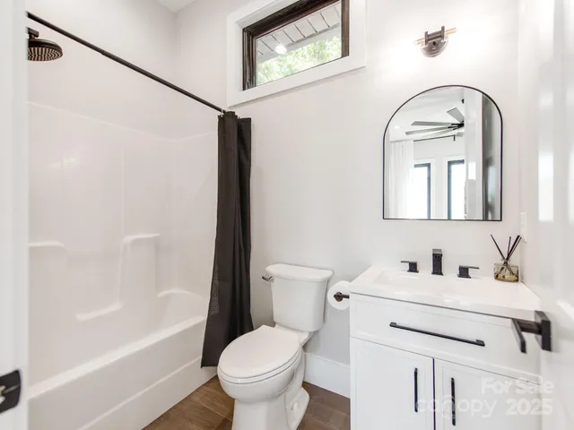 a bathroom with a toilet sink and a mirror