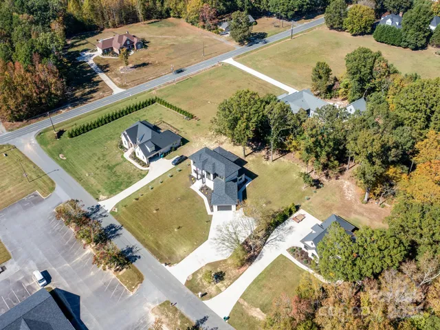 an aerial view of a house with a yard