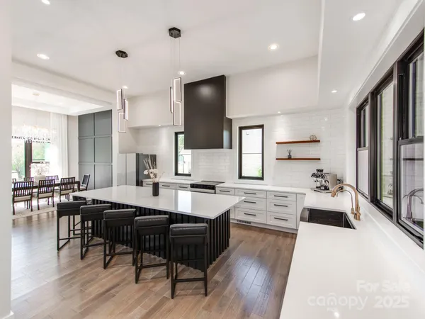 a large kitchen with cabinets table and chairs
